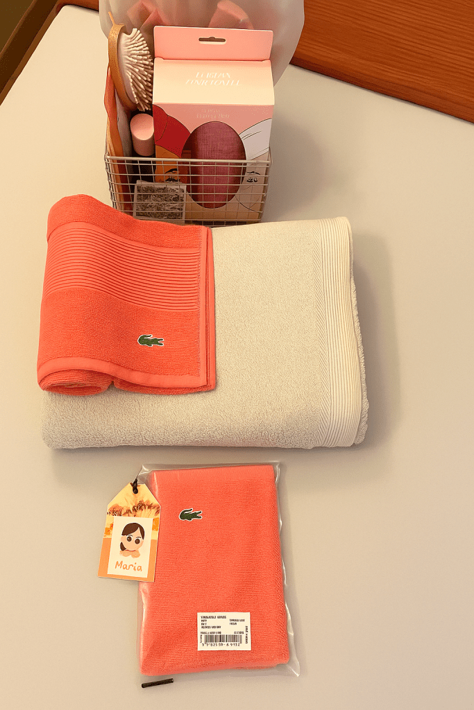 Me inspiré en los colores terracota de Provenza para esta cama, combinada con el color neutro arena. Para ella, toalla en color papaya Lecroco de Lacoste y para él el color tierra batida. En las cestas, turbantes-toalla para el pelo recién lavado, peine, agua micelar, crema hidratante, muestras de colonia, cuchillas, flores de ducha o esponjas, chanclas para la piscina, zapatillas de toalla...).